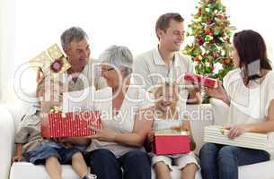Family opening Christmas gifts at home