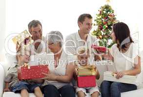 Happy family at home opening Christmas presents