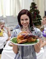 Woman showing to the camera Christmas turkey