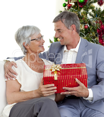 Senior man giving a Christmas present to his wife