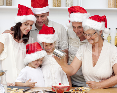 Happy family baking Christmas cakes