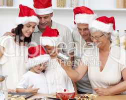 Happy family baking Christmas cakes