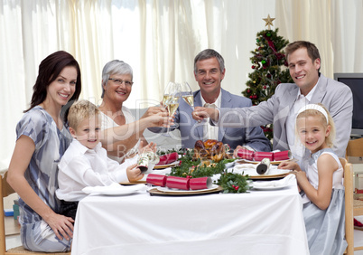 Family tusting in a Christmas dinner