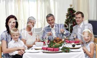 Family eating turkey in Christmas Eve Dinner