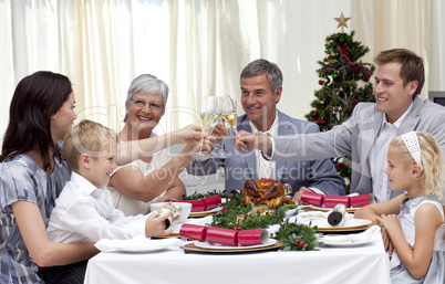 Family drinking a toast in a Christmas dinner