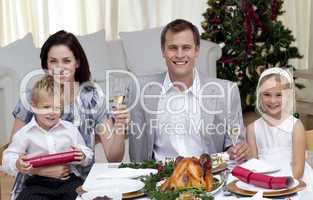 Parents toasting with champagne in Christmas dinner