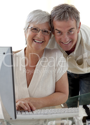 Happy senior couple using a computer