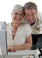 Happy senior couple using a computer
