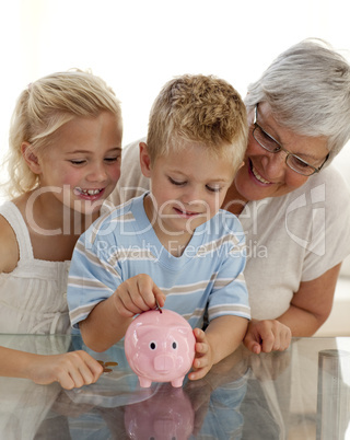 Close-up of grandmother and children saving money