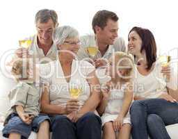 Family drinking wine and children eating biscuits