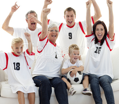 Family celebrating a goal at home