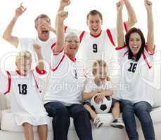 Family celebrating a goal at home