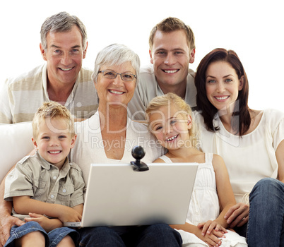 Happy family using a laptop at home