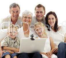 Happy family using a laptop at home