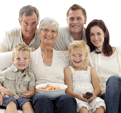 Portrait of family watching television and eating chips