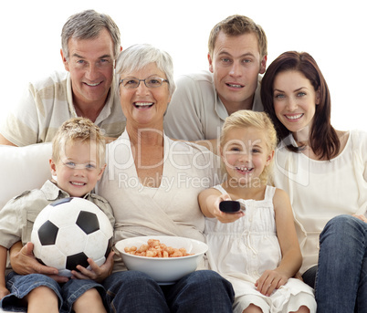 Happy family watching a football match at home