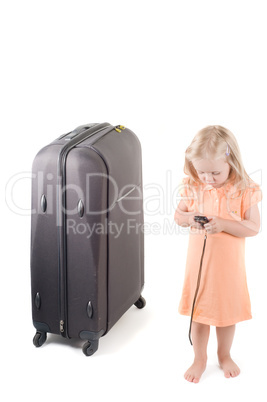 Little girl and suitcase in studio