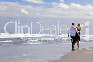 Man and Woman Couple Romantic Walk On A Beach