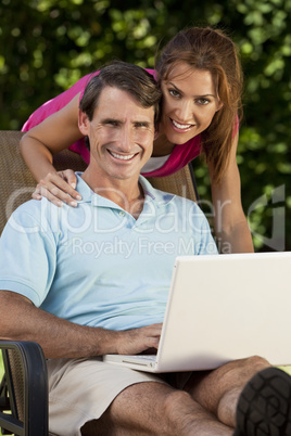 Happy Middle Aged Man and Woman Couple Using Laptop Computer