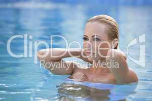 Beautiful Blond Woman In A Blue Swimming Pool
