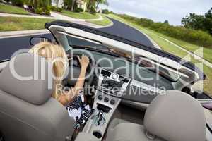 Beautiful Young Woman Driving Convertible Car