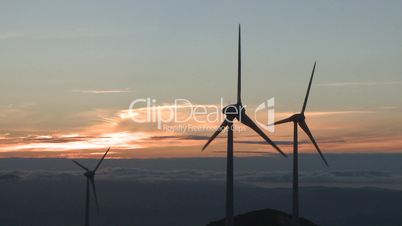 Wind turbine in the mountains at sunset