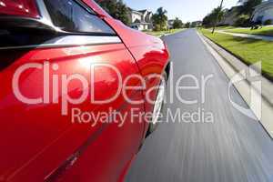 Car Driving at Speed on Suburban Street