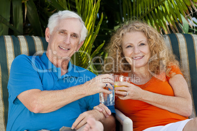 Senior Man and Woman Couple Enjoying Retirement Drinks on Vacati