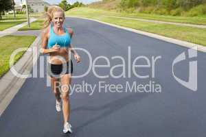 Beautiful Blond Woman Running and Listening to MP3 Player