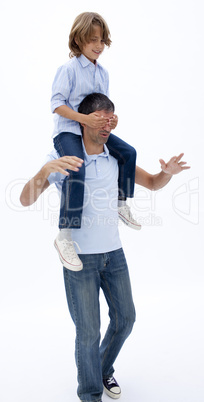 Father giving son piggyback ride with eyes closed