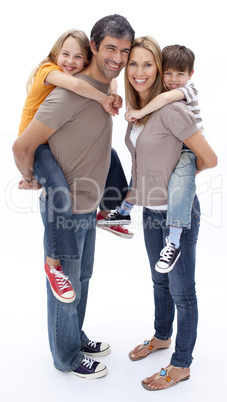 Parents giving children piggyback ride