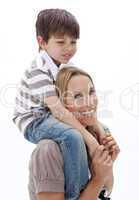 Close-up of mother giving son piggyback ride