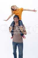 Father giving happy daughter piggyback ride