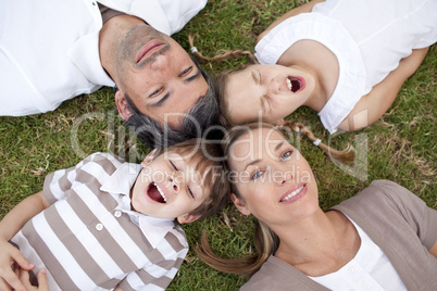 Tired family lying in a park