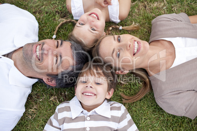 Tired family lying in a park