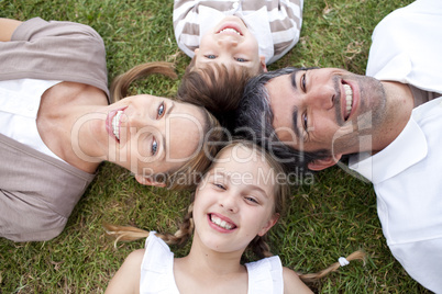 Happy family lying in a park