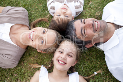 Smiling family lying outdoors