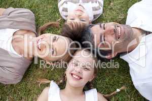 Smiling family lying outdoors