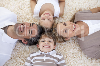 Family lying on floor with heads together