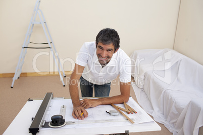 Smiling architect man decorating a bedroom