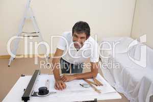 Smiling architect man decorating a bedroom