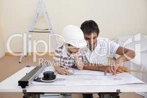 Father and son studying working with plans