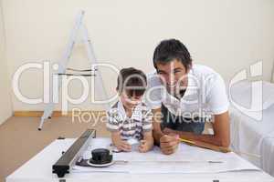Father and son making architectural works in bedroom