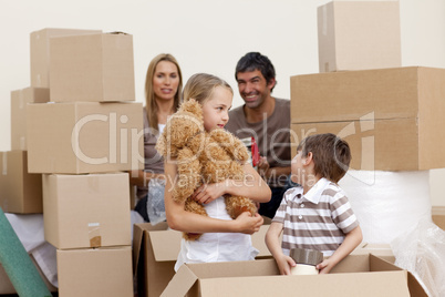 Family moving house playing with boxes