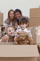Children unpacking boxes with their parents
