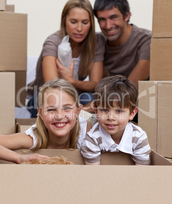 Portrait of children unpacking boxes with their parents