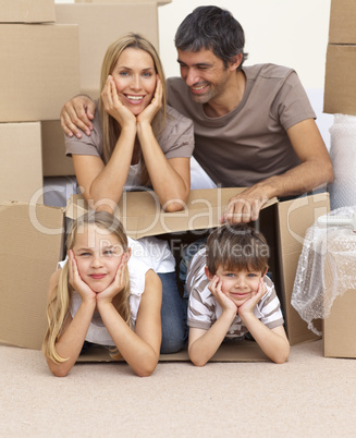 Family moving house playing with boxes