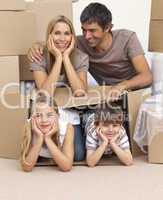 Family moving house playing with boxes