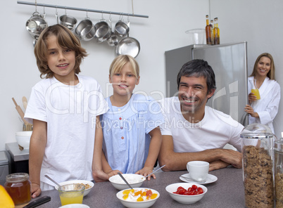 Smiling family preparing breakfast