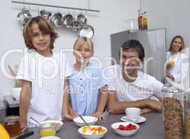 Smiling family preparing breakfast